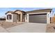 Lovely home featuring stone accents and a spacious two-car garage at 37650 W Nina St, Maricopa, AZ 85138