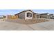 View of a home with desert landscaping and a wooden fence at 37650 W Nina St, Maricopa, AZ 85138