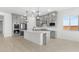 Bright kitchen with gray cabinetry, white counters, and modern stainless steel appliances at 37650 W Nina St, Maricopa, AZ 85138