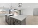 Kitchen island with sink, modern cabinets, and an open floor plan concept at 37650 W Nina St, Maricopa, AZ 85138