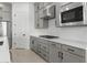 Beautiful kitchen featuring gray cabinets, quartz counters, and stainless steel appliances at 37650 W Nina St, Maricopa, AZ 85138