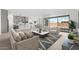 An open concept living room seamlessly connected to the modern kitchen at 37650 W Nina St, Maricopa, AZ 85138