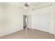Open bedroom with sliding closet and door leading to another room, and tile floors at 3805 S 73Rd Dr, Phoenix, AZ 85043