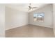 A bedroom features tile flooring, neutral paint, a bright window, and a ceiling fan at 3805 S 73Rd Dr, Phoenix, AZ 85043