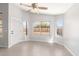 An empty dining room with neutral paint, tile floors, bright windows, and a ceiling fan at 3805 S 73Rd Dr, Phoenix, AZ 85043