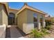 Home entrance with unique archway, desert landscaping, and neutral exterior paint at 3805 S 73Rd Dr, Phoenix, AZ 85043