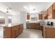 Bright kitchen with island, wood cabinets, granite countertops, tile floors, and stainless appliances at 3805 S 73Rd Dr, Phoenix, AZ 85043