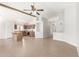 Spacious open floor plan with tile flooring, kitchen island, and a view to a dining area at 3805 S 73Rd Dr, Phoenix, AZ 85043