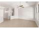Open-concept living room with tile flooring, high ceilings, neutral paint, and ceiling fan at 3805 S 73Rd Dr, Phoenix, AZ 85043