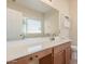 Bathroom area featuring a dual sink vanity, large mirror, and neutral color tones at 41444 W Capistrano Dr, Maricopa, AZ 85138