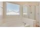 Bathroom area with a soaking tub and a separate glass-enclosed shower at 41444 W Capistrano Dr, Maricopa, AZ 85138