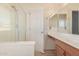 Bathroom with a glass-enclosed shower, a vanity with sink, and lighting fixtures at 41444 W Capistrano Dr, Maricopa, AZ 85138