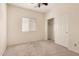 Neutral bedroom featuring a window, plush carpet, and a closet for ample storage at 41444 W Capistrano Dr, Maricopa, AZ 85138