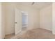 Carpeted bedroom with double doors leading to an adjacent room and neutral decor at 41444 W Capistrano Dr, Maricopa, AZ 85138