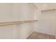 Walk in closet features built-in shelving and rods for storage at 41444 W Capistrano Dr, Maricopa, AZ 85138