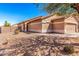 Well-maintained single-story home with desert landscaping, a two-car garage, and a fire hydrant at 41444 W Capistrano Dr, Maricopa, AZ 85138