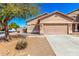 Charming single-story home featuring a desert landscape, covered entryway, and a two-car garage at 41444 W Capistrano Dr, Maricopa, AZ 85138