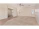 Spacious living room with carpet and tile flooring, featuring multiple windows and neutral walls at 41444 W Capistrano Dr, Maricopa, AZ 85138