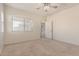 Spacious main bedroom with carpet flooring and natural light from the window at 41444 W Capistrano Dr, Maricopa, AZ 85138