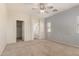 Neutral main bedroom with ceiling fan and window offering natural light at 41444 W Capistrano Dr, Maricopa, AZ 85138