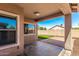 Covered patio with concrete flooring and block wall overlooking the backyard at 41444 W Capistrano Dr, Maricopa, AZ 85138