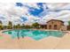 Beautiful community pool with sun loungers and patio seating with shade perfect for enjoyment and relaxation at 41444 W Capistrano Dr, Maricopa, AZ 85138
