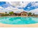 Inviting community pool with ample seating and a charming clubhouse, perfect for summer enjoyment at 41444 W Capistrano Dr, Maricopa, AZ 85138