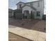Charming two-story home featuring stucco exterior, gray accent colors, and a well-manicured front yard at 43372 N Wollemi St, Queen Creek, AZ 85140