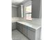 Well-lit kitchen with gray cabinets, white countertops and tiled backsplash at 43372 N Wollemi St, Queen Creek, AZ 85140