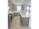 Well-equipped kitchen featuring an island with a sink, modern appliances, and access to the outdoor patio at 43372 N Wollemi St, Queen Creek, AZ 85140