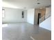 Bright living room with tile flooring, windows, and staircase at 43372 N Wollemi St, Queen Creek, AZ 85140