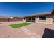 The property features a low maintenance backyard with artificial turf, rock ground cover, and mountain views at 4557 W South Butte Rd, San Tan Valley, AZ 85144