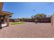 Backyard with desert landscaping, a storage shed, and mature trees at 4557 W South Butte Rd, San Tan Valley, AZ 85144