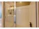Bathroom showcasing a tiled shower with glass doors, chrome fixtures, and shower seat at 4557 W South Butte Rd, San Tan Valley, AZ 85144
