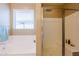 Bathroom with separate tub and shower with tiled walls and a large window at 4557 W South Butte Rd, San Tan Valley, AZ 85144