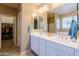Bathroom with large mirror over dual sinks, walk-in closet, and tub shower at 4557 W South Butte Rd, San Tan Valley, AZ 85144