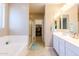 Bright bathroom with separate tub and shower, dual sinks and walk-in closet at 4557 W South Butte Rd, San Tan Valley, AZ 85144