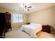 Well-lit bedroom features a ceiling fan, large window and carpeted floors at 4557 W South Butte Rd, San Tan Valley, AZ 85144