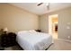 Cozy bedroom with neutral walls, carpet, and an ensuite bath with walk-in closet at 4557 W South Butte Rd, San Tan Valley, AZ 85144