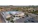 Aerial view of the San Tan Heights Center featuring parking, a pool, and desert landscaping at 4557 W South Butte Rd, San Tan Valley, AZ 85144