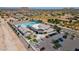 Aerial view of community center with pool, parking, landscaping, and desert neighborhood in background at 4557 W South Butte Rd, San Tan Valley, AZ 85144