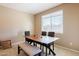 Cozy dining room with a wooden table, bench seating, and a window providing natural light at 4557 W South Butte Rd, San Tan Valley, AZ 85144