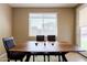 Bright dining room with a wooden table, modern chairs, and natural light from a large window at 4557 W South Butte Rd, San Tan Valley, AZ 85144