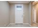 Bright entryway featuring a neutral color scheme and a glass paneled front door at 4557 W South Butte Rd, San Tan Valley, AZ 85144