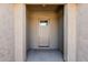 Neutral toned entryway with glass paneled front door and textured wall finish at 4557 W South Butte Rd, San Tan Valley, AZ 85144
