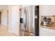 Modern kitchen featuring a stainless steel refrigerator and a built-in espresso machine at 4557 W South Butte Rd, San Tan Valley, AZ 85144