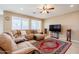 Comfortable living room featuring large sectional couch and tile flooring at 4557 W South Butte Rd, San Tan Valley, AZ 85144