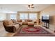 Spacious living room features a large sectional and bright, natural lighting at 4557 W South Butte Rd, San Tan Valley, AZ 85144