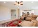 Inviting living room with a plush sectional sofa and a decorative rug, open to the modern kitchen at 4557 W South Butte Rd, San Tan Valley, AZ 85144