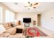 Bright living room with large sectional sofa, neutral tones, and tile floors at 4557 W South Butte Rd, San Tan Valley, AZ 85144